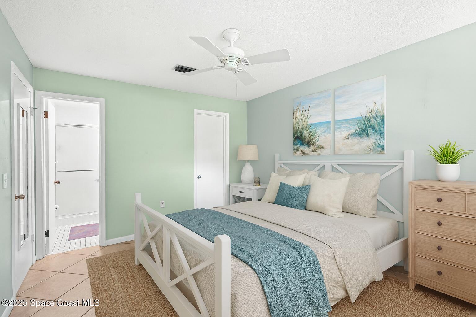 2902 Emory Street Melbourne, FL 32901 - Photo 39 of 46 a bedroom with a bed and a chandelier