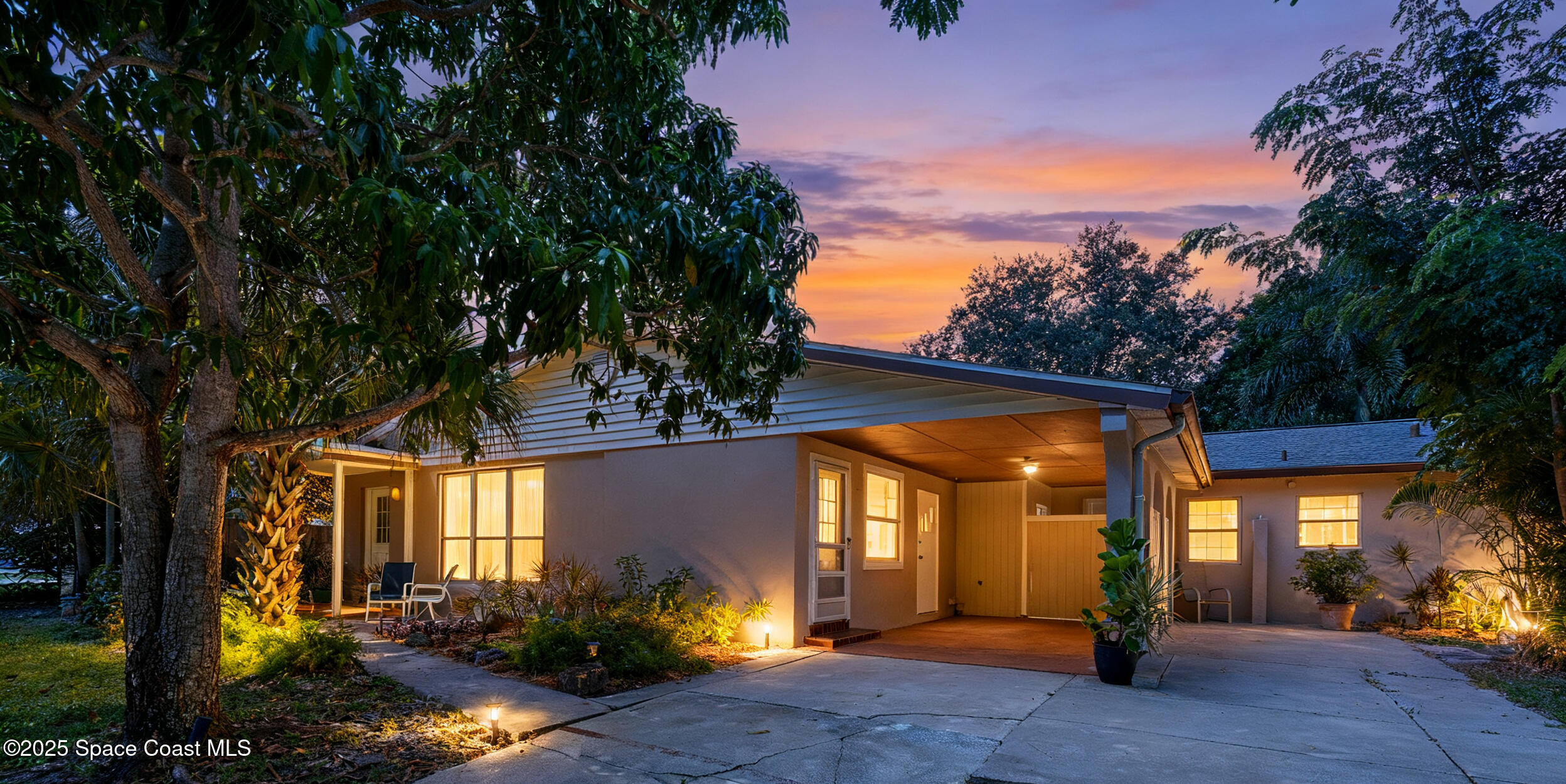 2902 Emory Street Melbourne, FL 32901 - Photo 4 of 46 a view of a house with large trees and plants
