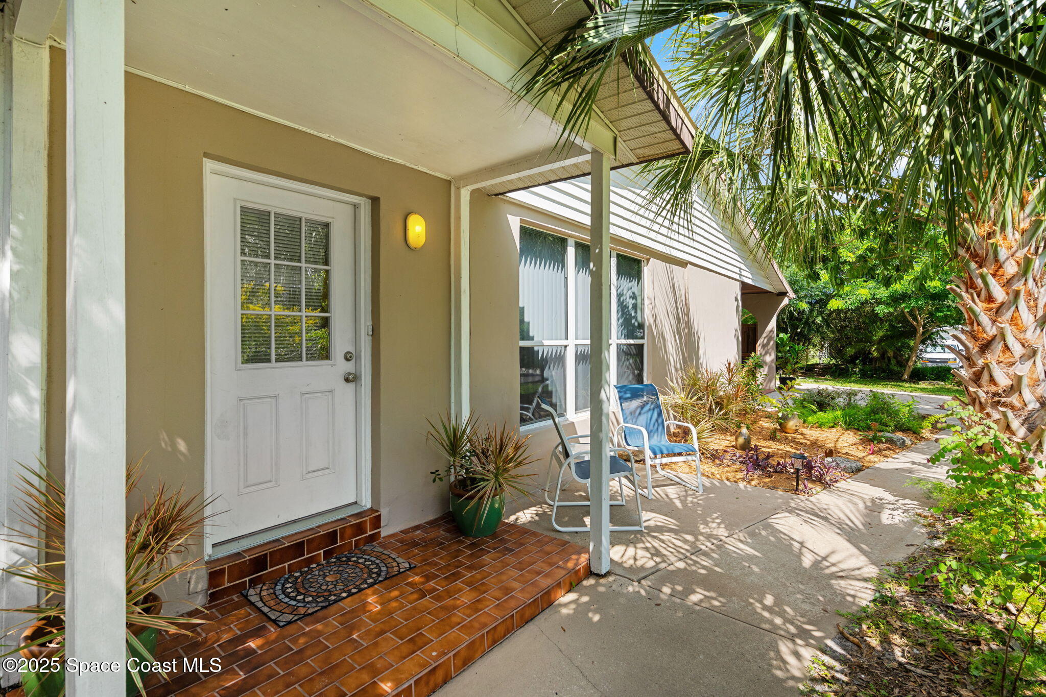 2902 Emory Street Melbourne, FL 32901 - Photo 5 of 46 a backyard of a house with table and chairs and potted plants