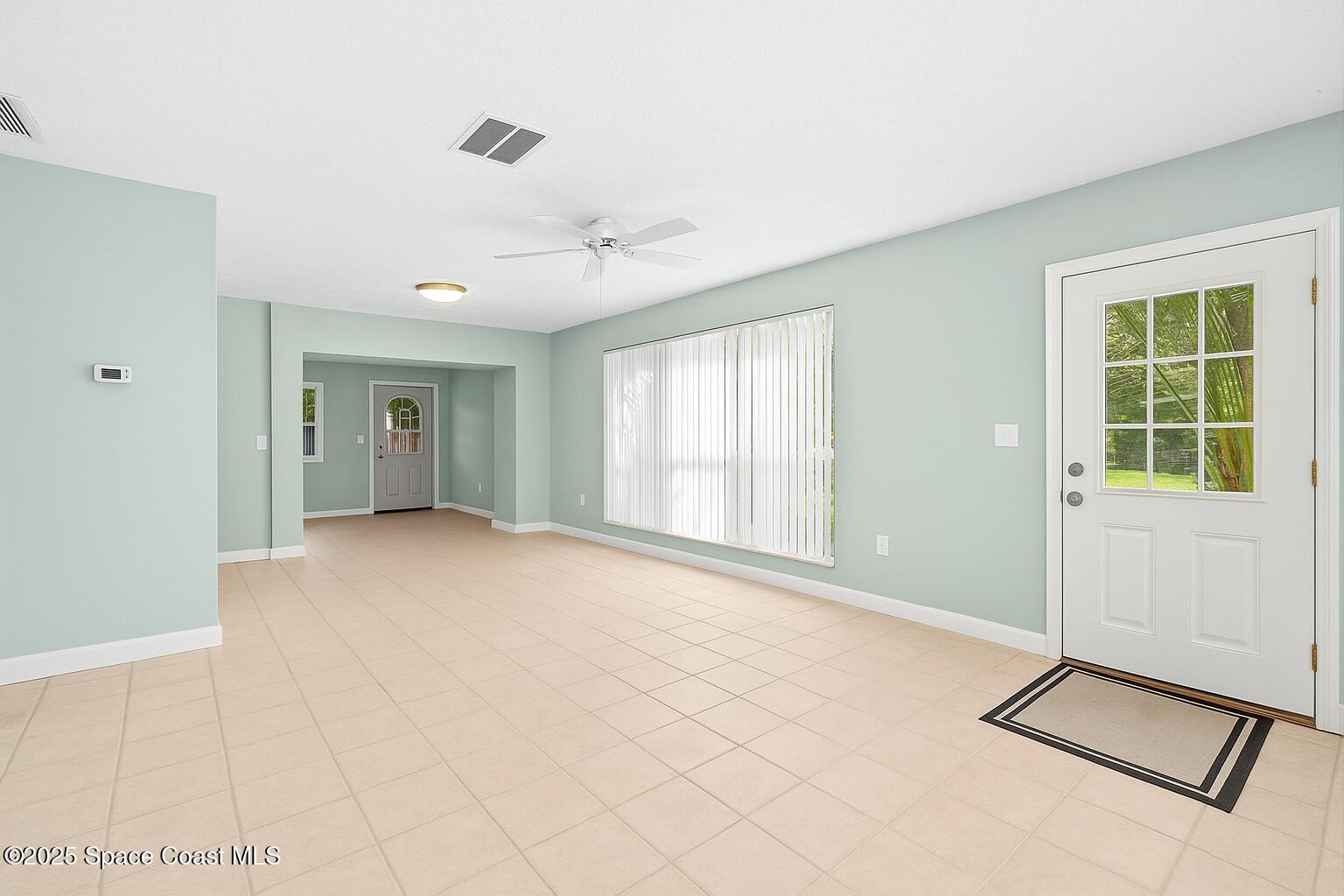 2902 Emory Street Melbourne, FL 32901 - Photo 6 of 46 a view of an empty room with window and a livingroom
