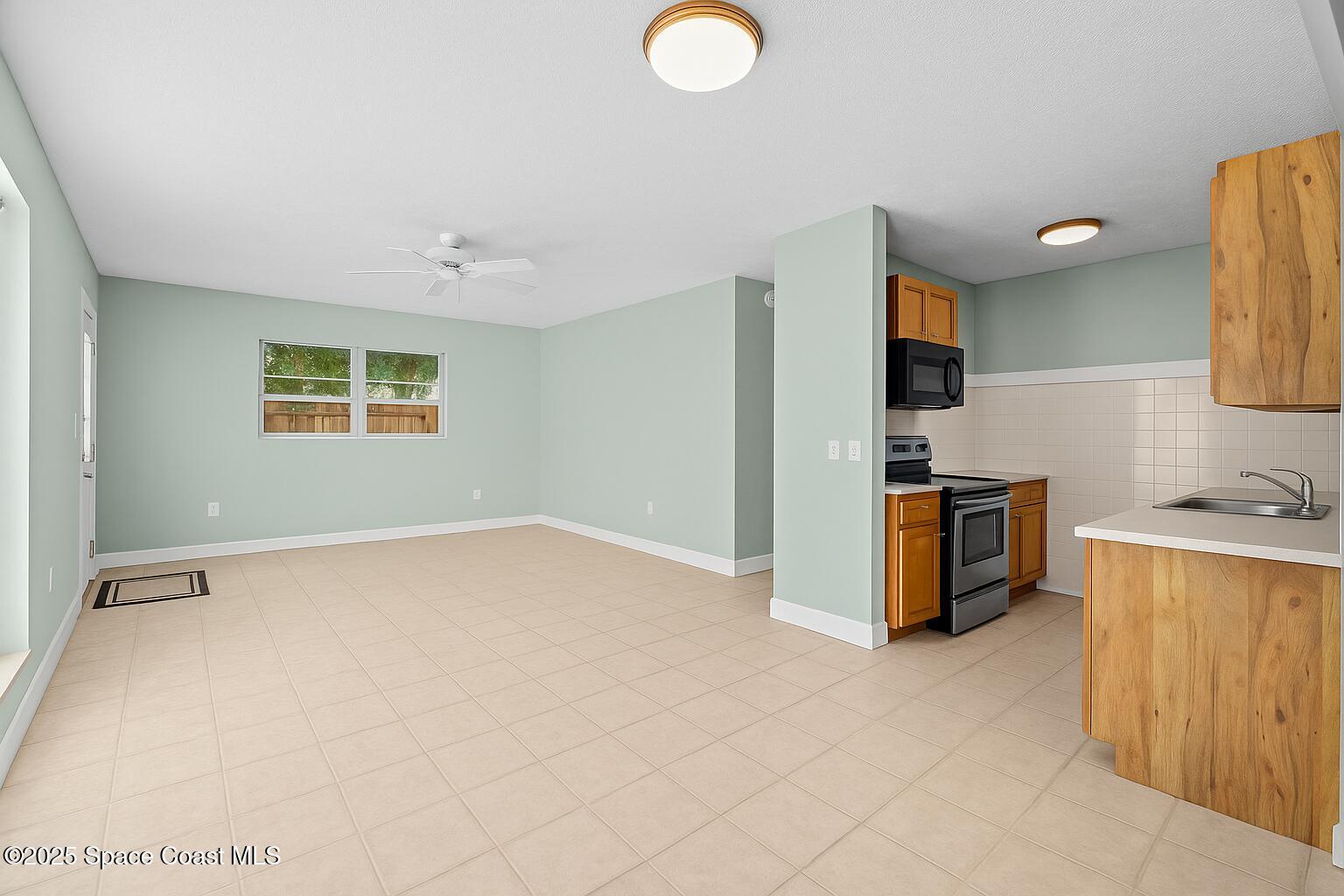 2902 Emory Street Melbourne, FL 32901 - Photo 7 of 46 a view of a kitchen with microwave and cabinets