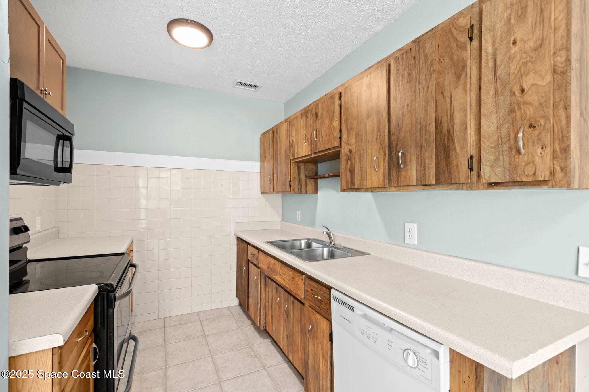 2902 Emory Street Melbourne, FL 32901 - Photo 8 of 46 a kitchen with a cabinets a sink and a stove