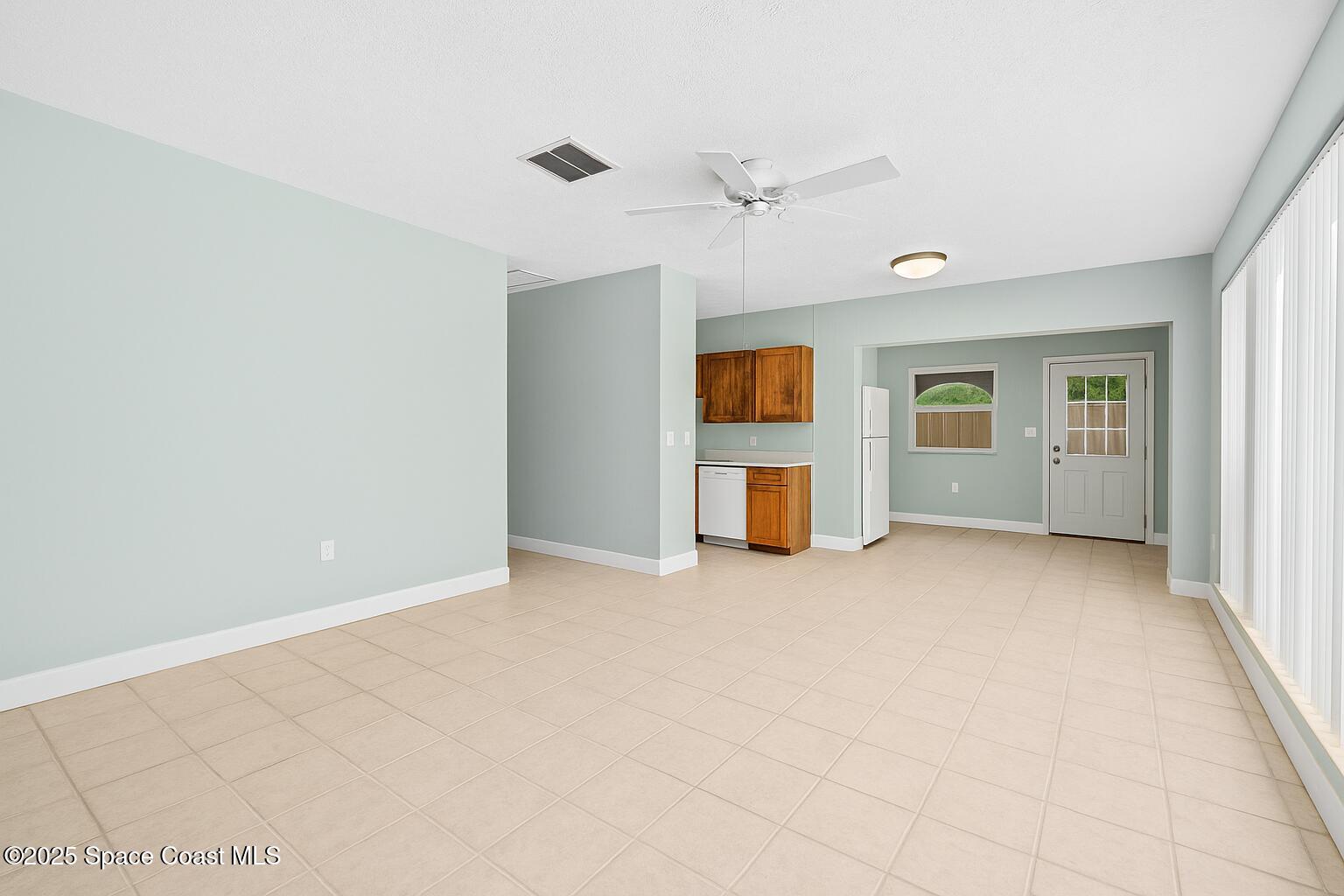 2902 Emory Street Melbourne, FL 32901 - Photo 10 of 46 an empty room with windows and ceiling fan