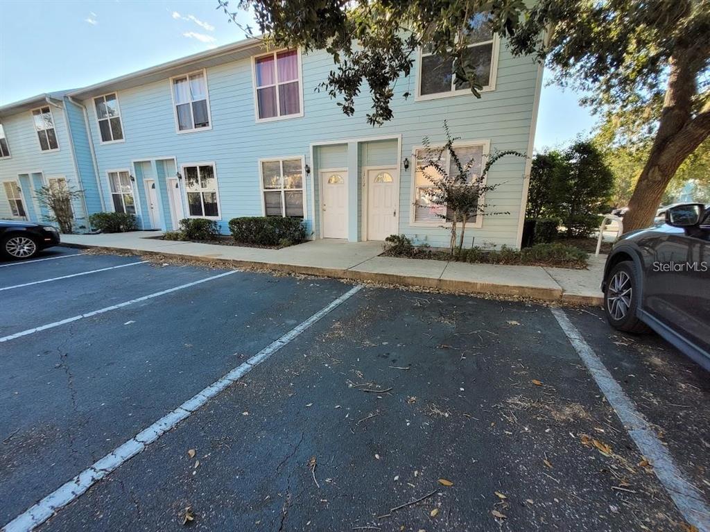 3890 Southwest 20th Avenue, Unit 1712 Gainesville, FL 32607 - Photo 17 of 19 a front view of a house with a yard