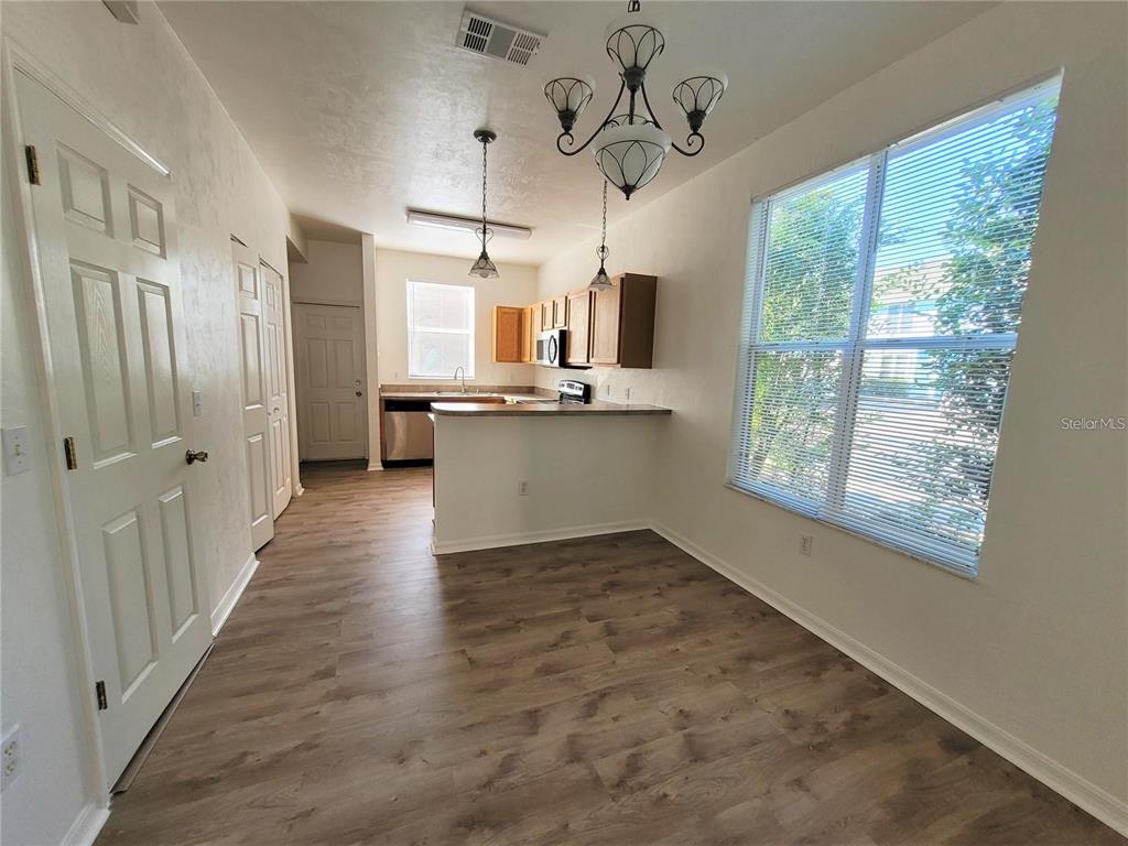 3890 Southwest 20th Avenue, Unit 1712 Gainesville, FL 32607 - Photo 4 of 19 a view of a kitchen with a sink wooden floor and windows