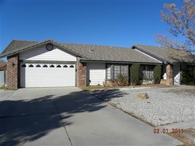 13456 Cochise Road Apple Valley, CA 92308 - Photo 1 of 1 a front view of a house with garden