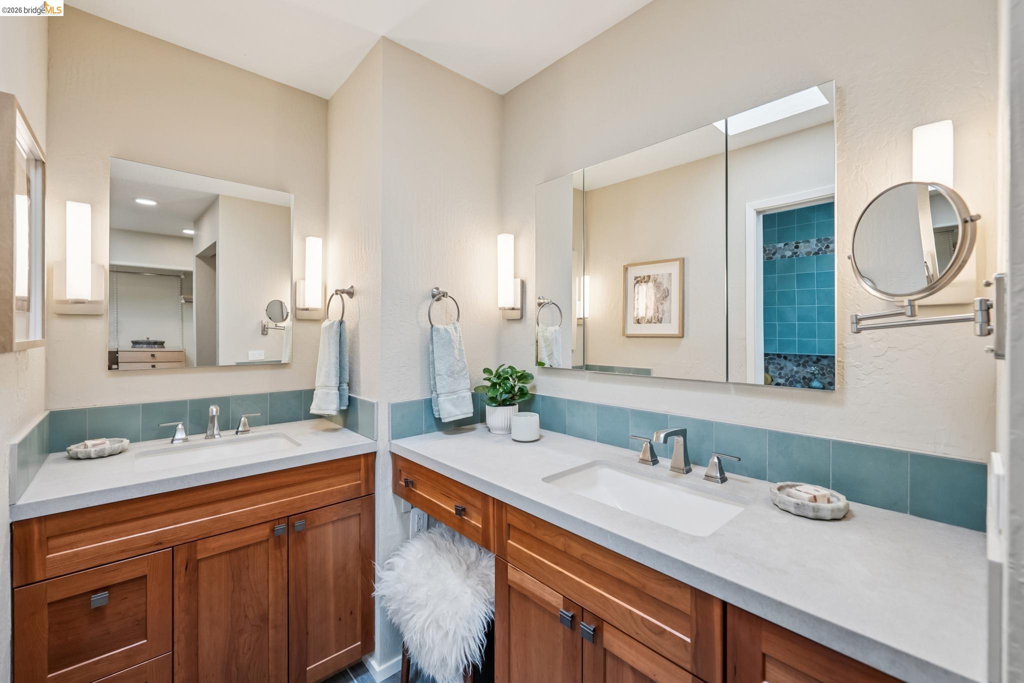 576 Vistamont Avenue Berkeley, CA 94708 - Photo 22 of 33 Dual vanity bathroom featuring light-toned walls and wood cabinetry