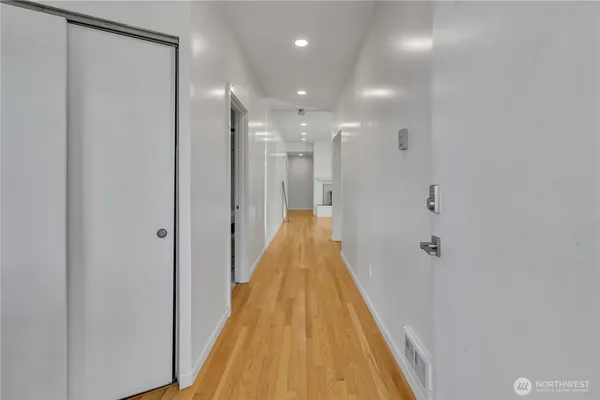 a view of a bathroom with mirror and shower