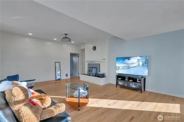 a living room with furniture a flat screen tv and a dining table