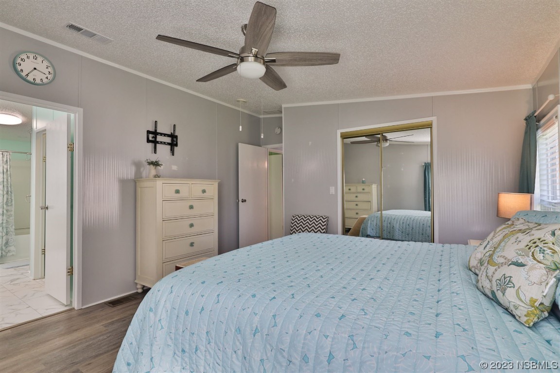 502 Topside Circle Edgewater, FL 32141 - Photo 14 of 28 a bedroom with a bed and a dresser