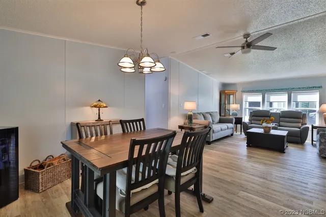a view of a dining room with furniture wooden floor and chandelier
