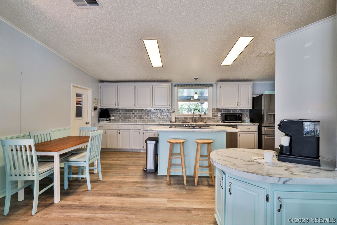 502 Topside Circle Edgewater, FL 32141 - Photo 10 of 28 a kitchen with white cabinets and counter space