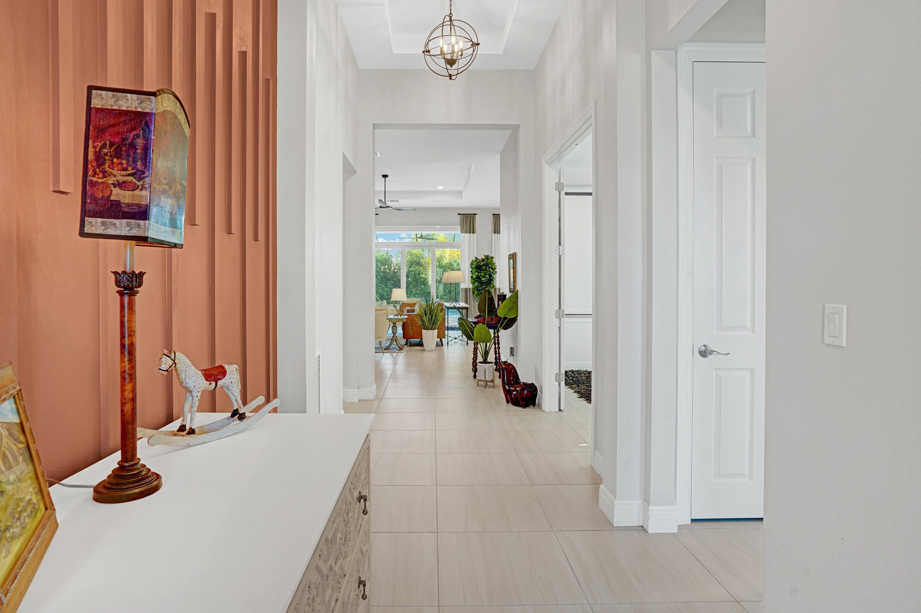23005 Southwest Accesi Way Port St. Lucie, FL 34986 - Photo 12 of 80 a view of a livingroom with wooden floor and a chandelier