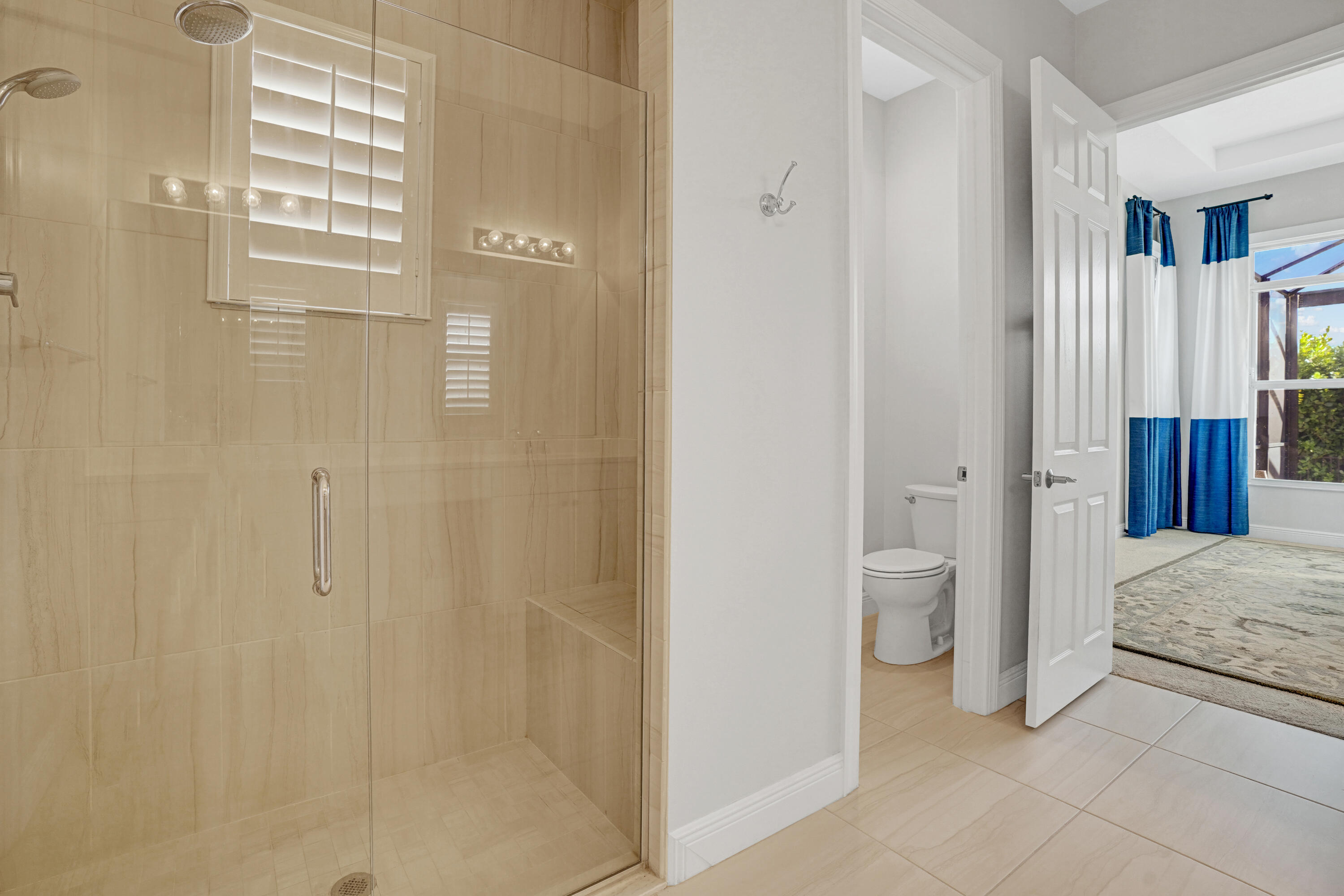 23005 Southwest Accesi Way Port St. Lucie, FL 34986 - Photo 31 of 80 a bathroom with a granite countertop sink a toilet and shower