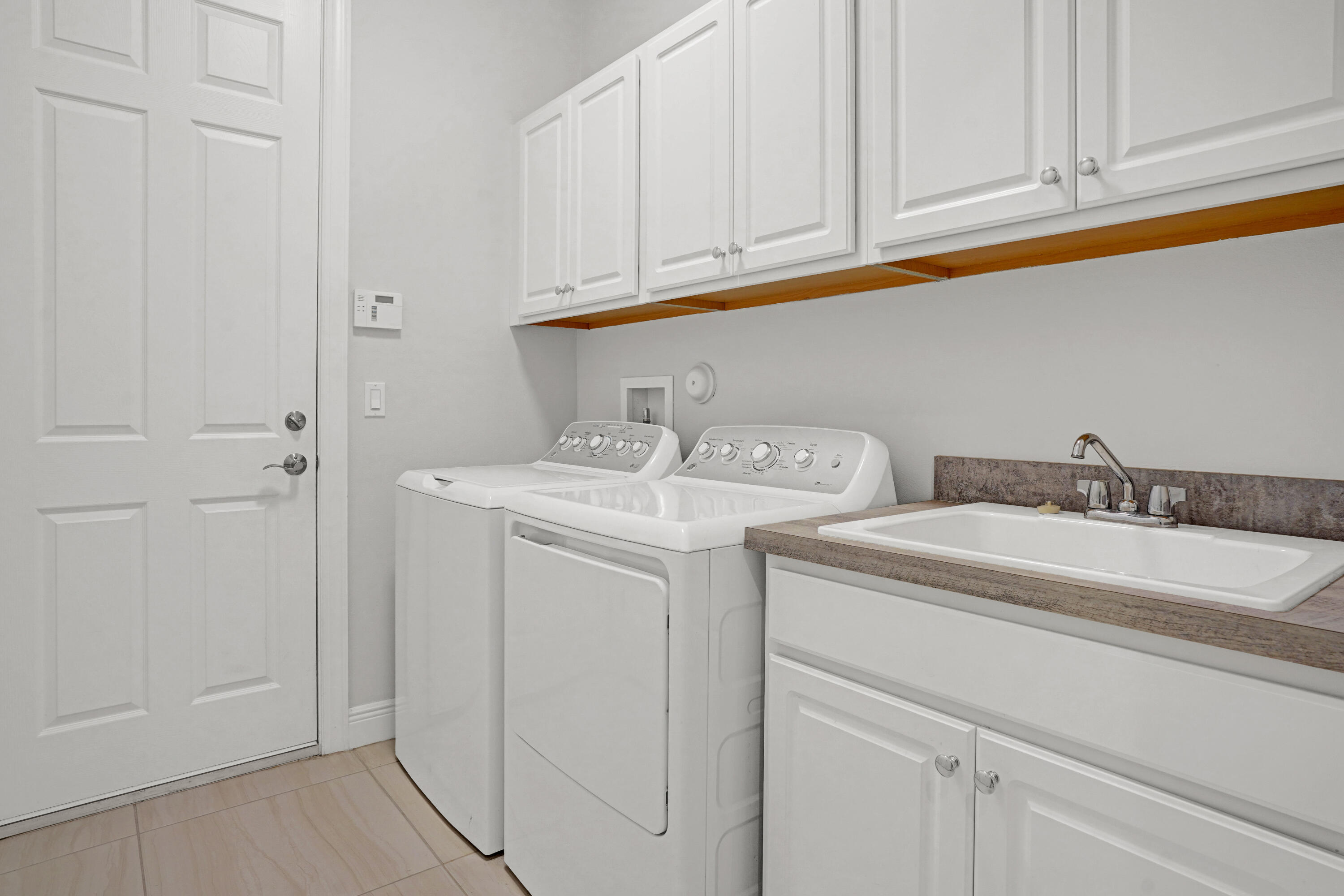 23005 Southwest Accesi Way Port St. Lucie, FL 34986 - Photo 38 of 80 a utility room with dryer and washer