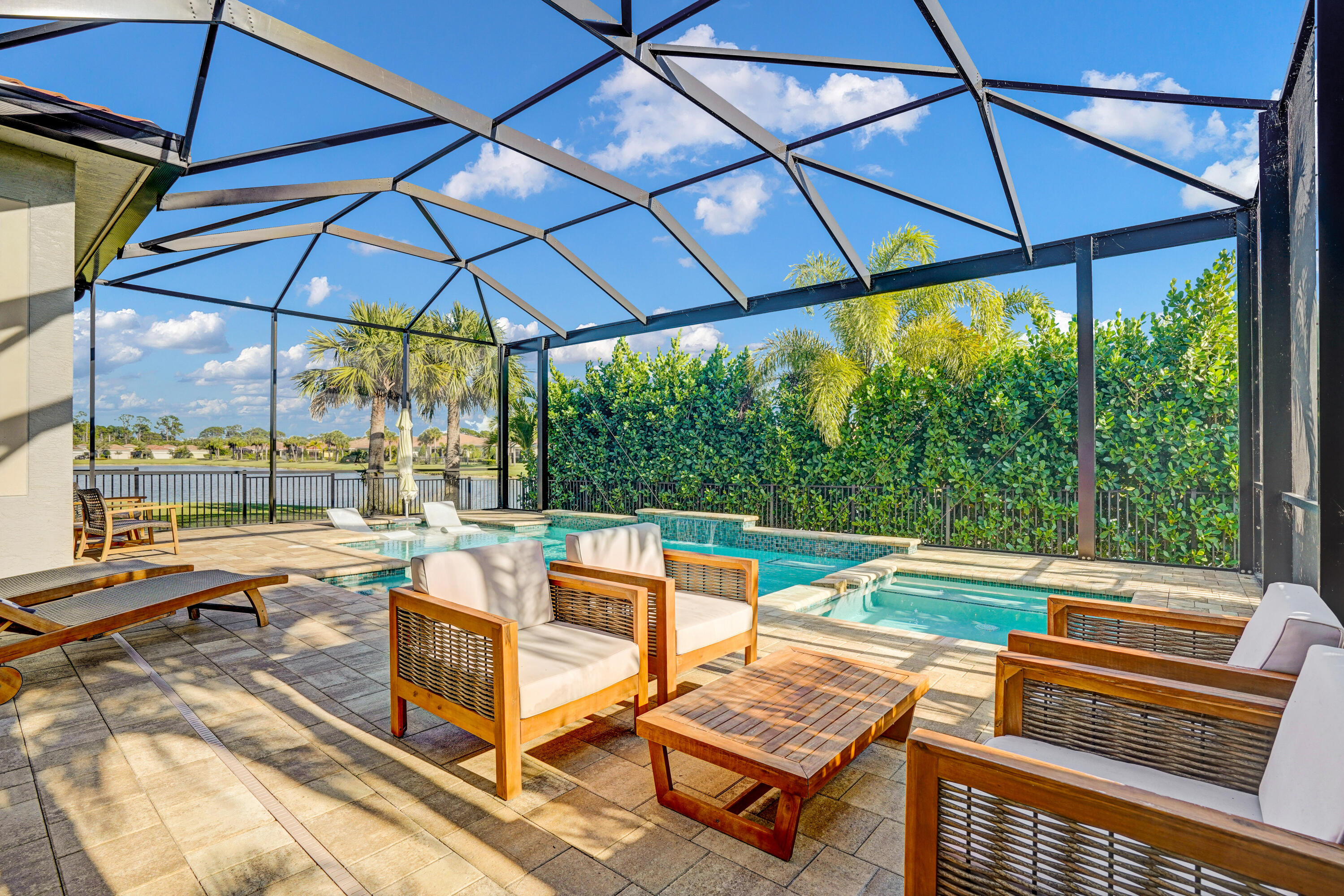 23005 Southwest Accesi Way Port St. Lucie, FL 34986 - Photo 40 of 80 a view of a outdoor sitting area with furniture and umbrella