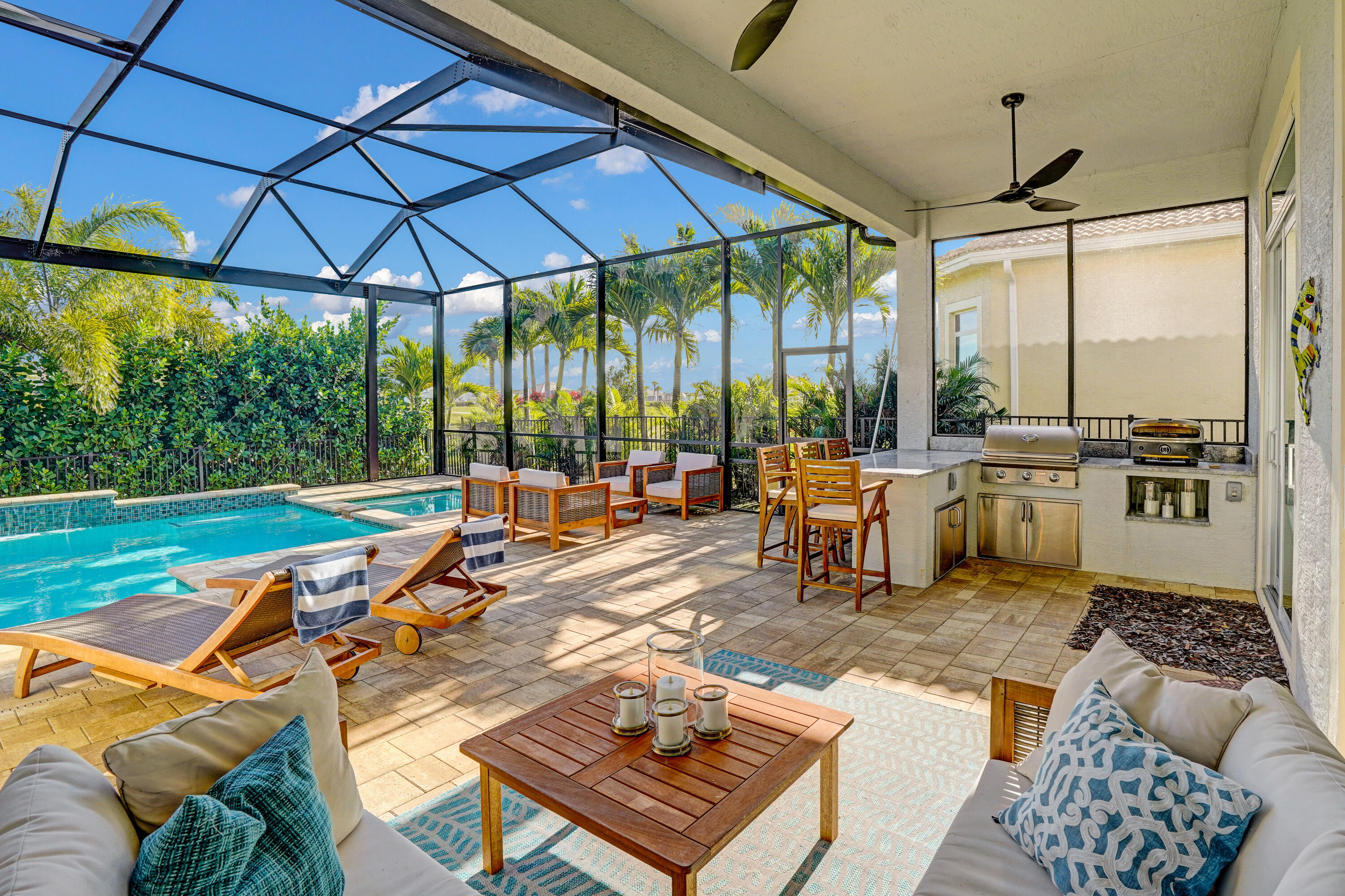 23005 Southwest Accesi Way Port St. Lucie, FL 34986 - Photo 41 of 80 a view of a patio with chairs and table under an umbrella