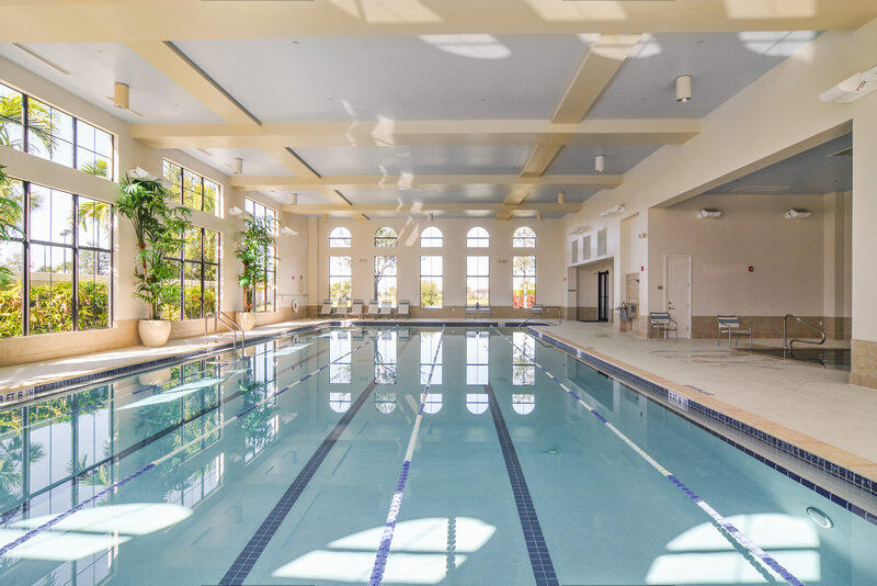 23005 Southwest Accesi Way Port St. Lucie, FL 34986 - Photo 65 of 80 a large white kitchen with kitchen island a large window a sink and a counter top space