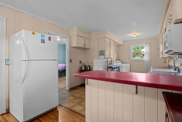 a kitchen with refrigerator and cabinets