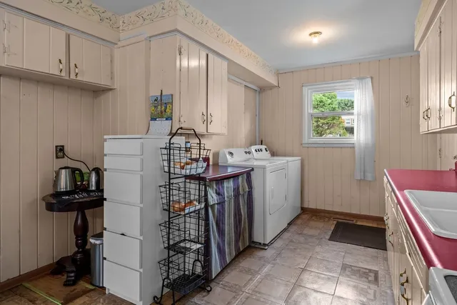 a view of utility room with cabinets
