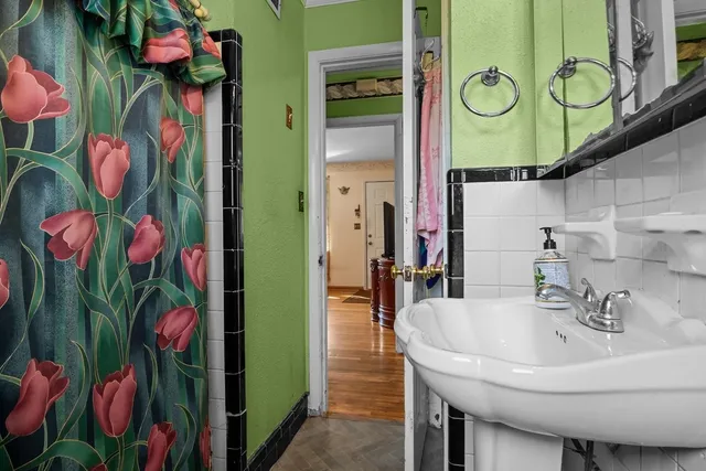 a bathroom with a sink mirror and vanity