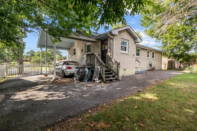 a view of a car park in front of a house
