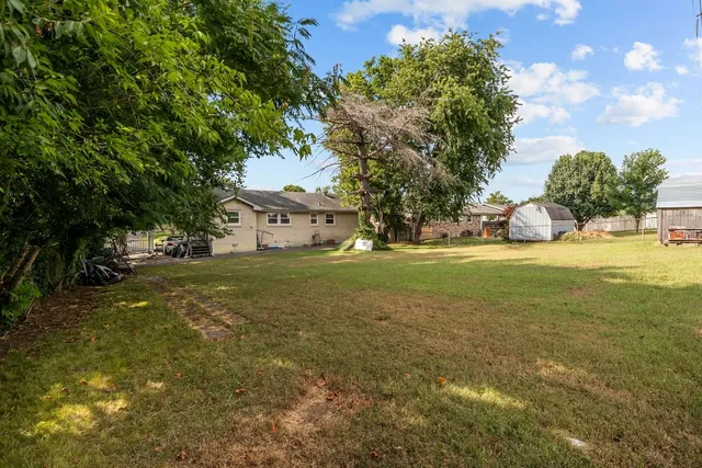 a view of a tree in front of a house