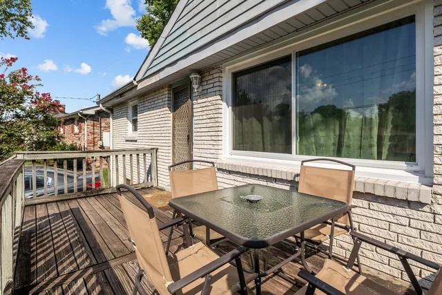 a view of a patio with a table and chairs