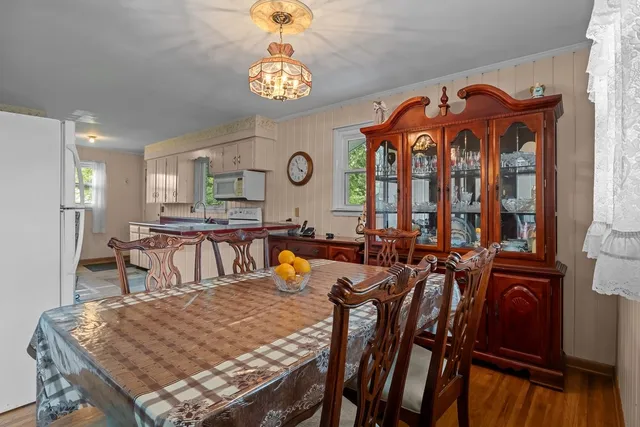 a view of a dining room with furniture and a chandelier