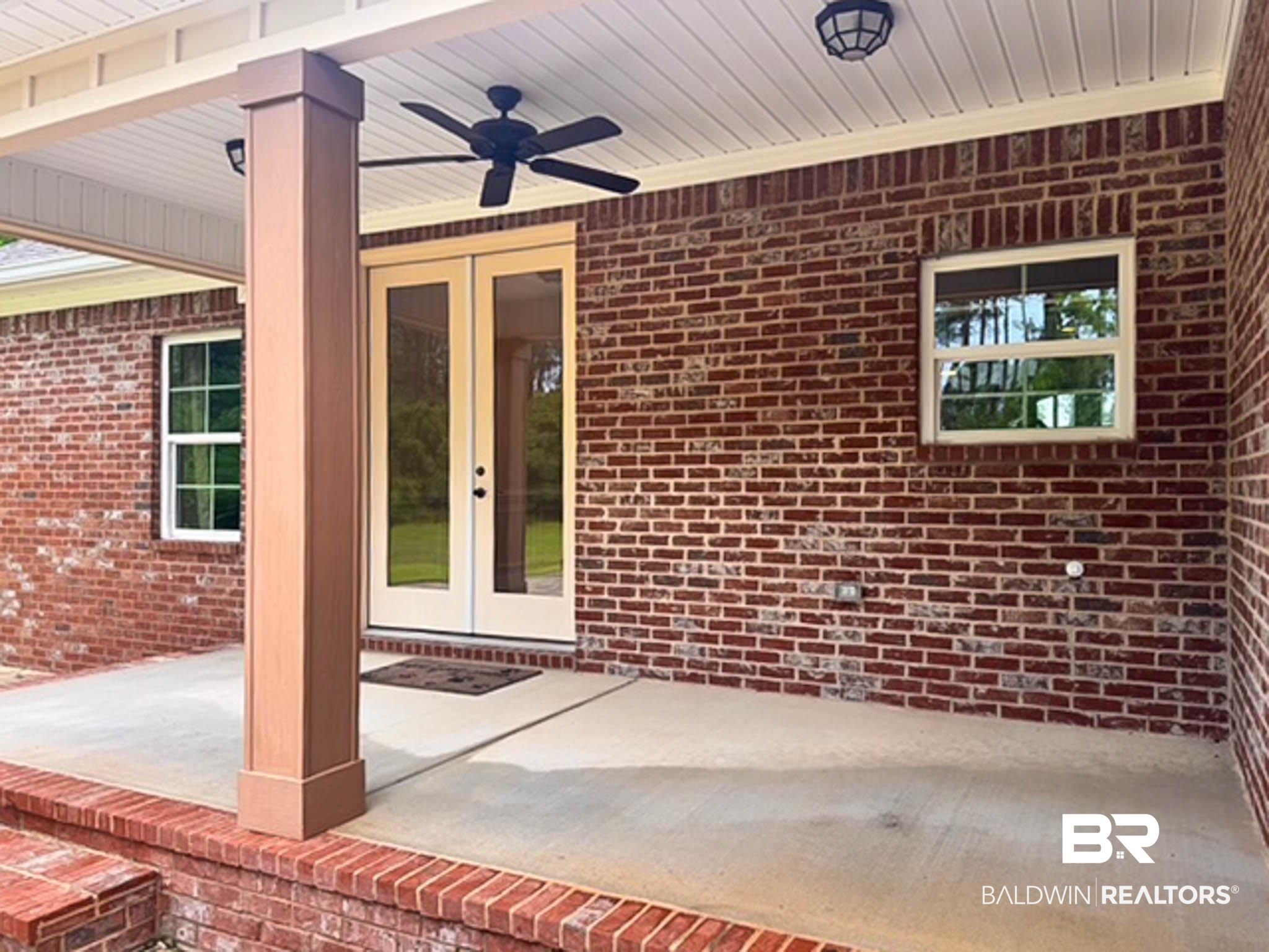 8145 Bay View Drive Foley, AL 36535 - Photo 56 of 81 Entrance to property featuring french doors, a ceiling fan, a patio area, and brick siding