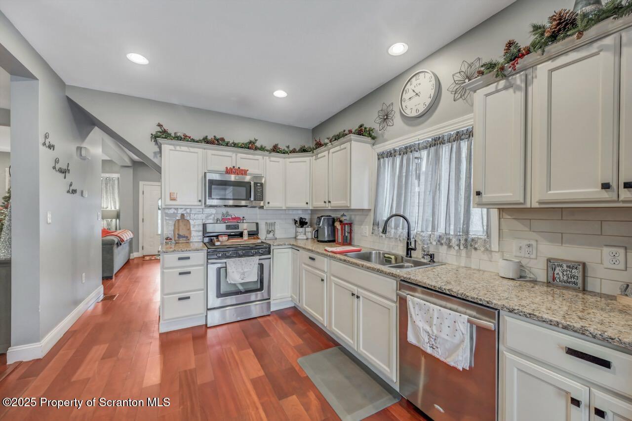 1531 Electric Street Dunmore, PA 18509 - Photo 18 of 56 a large kitchen with stainless steel appliances granite countertop a lot of counter space and wooden floors