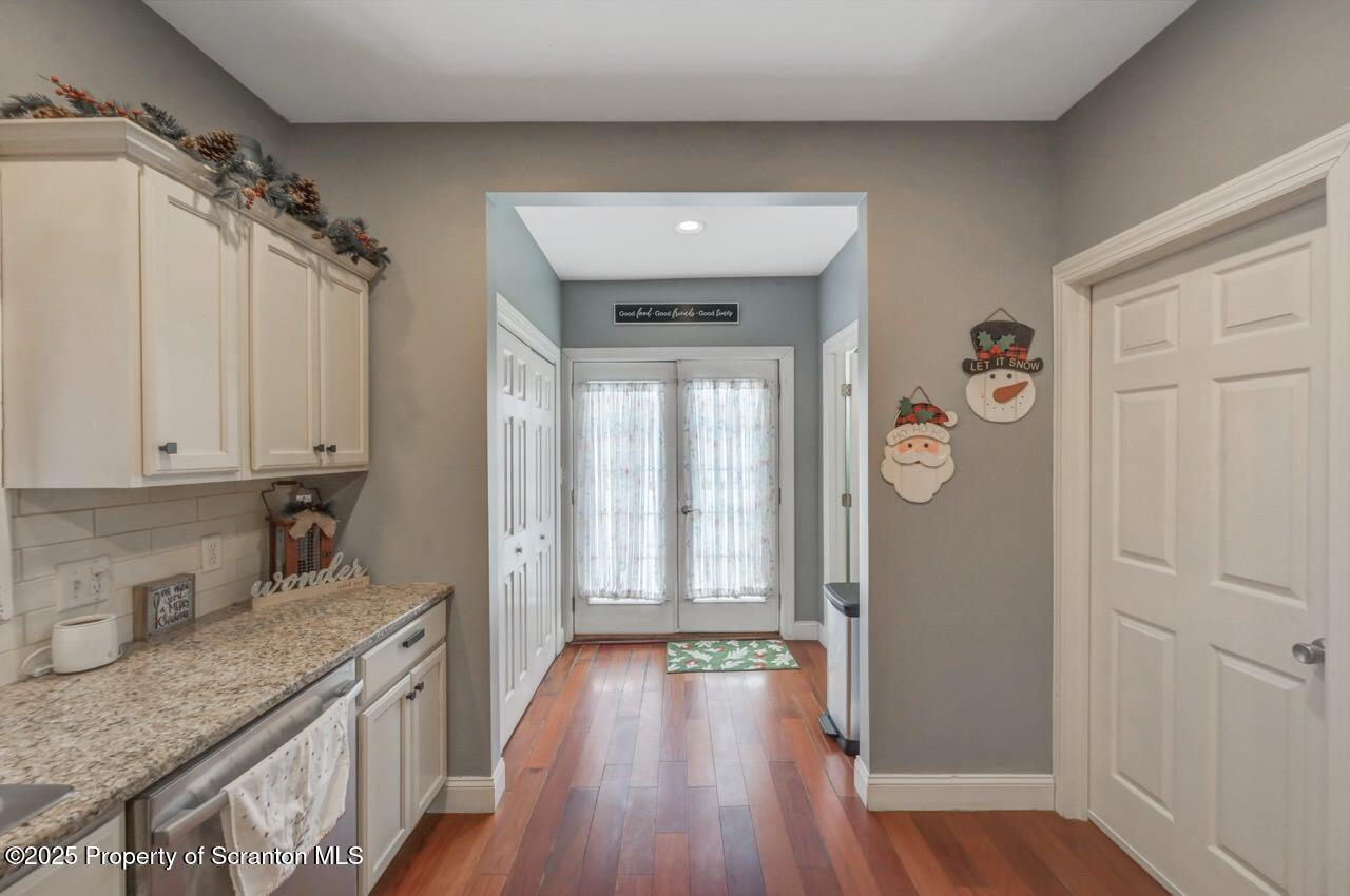 1531 Electric Street Dunmore, PA 18509 - Photo 20 of 56 a kitchen with granite countertop a refrigerator and wooden floor