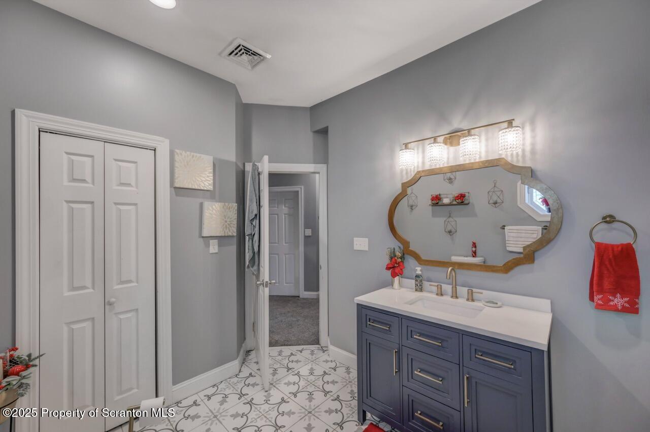 1531 Electric Street Dunmore, PA 18509 - Photo 35 of 56 a bathroom with a sink vanity and a mirror