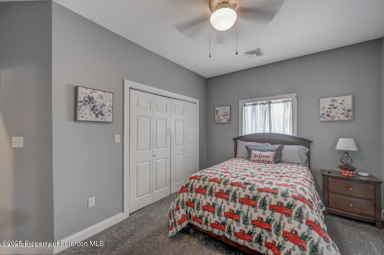 1531 Electric Street Dunmore, PA 18509 - Photo 41 of 56 a bedroom with a bed and a lamp on dresser