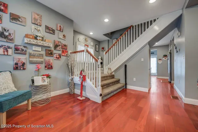 a view of entryway with wooden floor and stairs