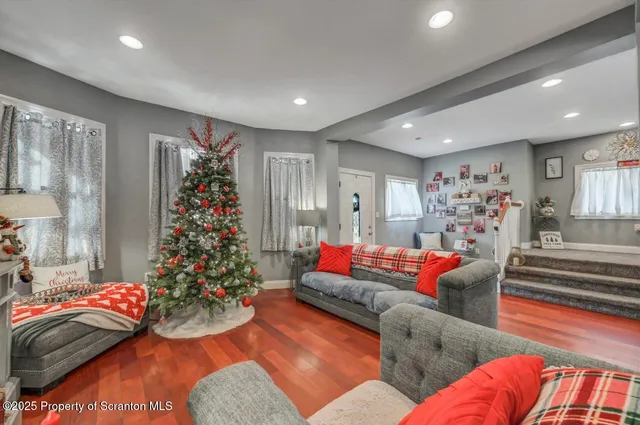 a living room with furniture and flowers