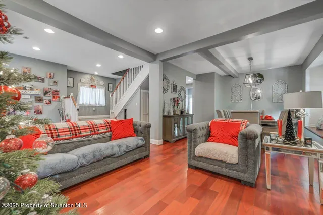 a living room filled with furniture and a wooden floor