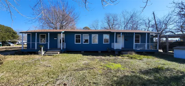 a view of a house with a yard and sitting area