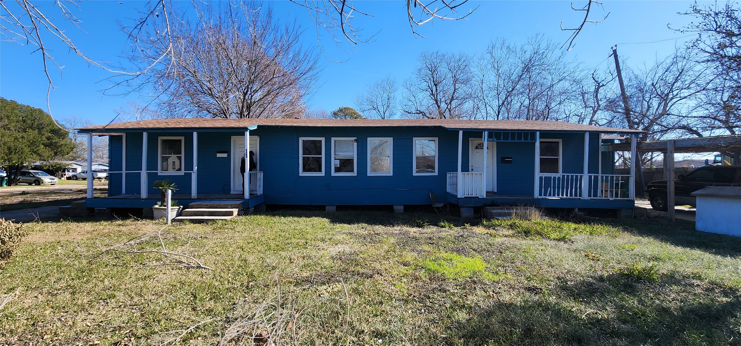 a view of a house with a yard and sitting area