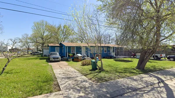 a view of a yard with a house and a tree