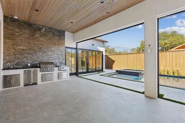 a view of a livingroom with furniture and floor to ceiling window