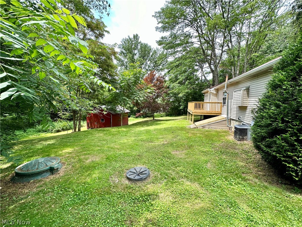 48963 Bloomfield Road East Liverpool, OH 43920 - Photo 21 of 25 View of yard with a wooden deck, central air condition unit, and a shed