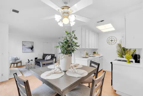 a view of a dining room with furniture and chandelier