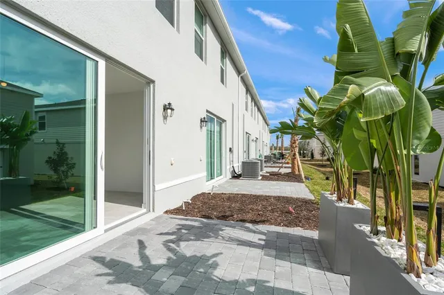 a view of a house with backyard and sitting area