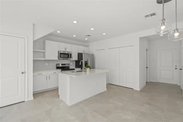 a living room with stainless steel appliances kitchen island furniture and view kitchen
