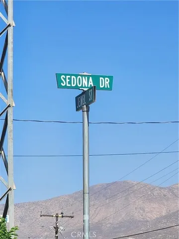 a view of a dry yard with wooden fence