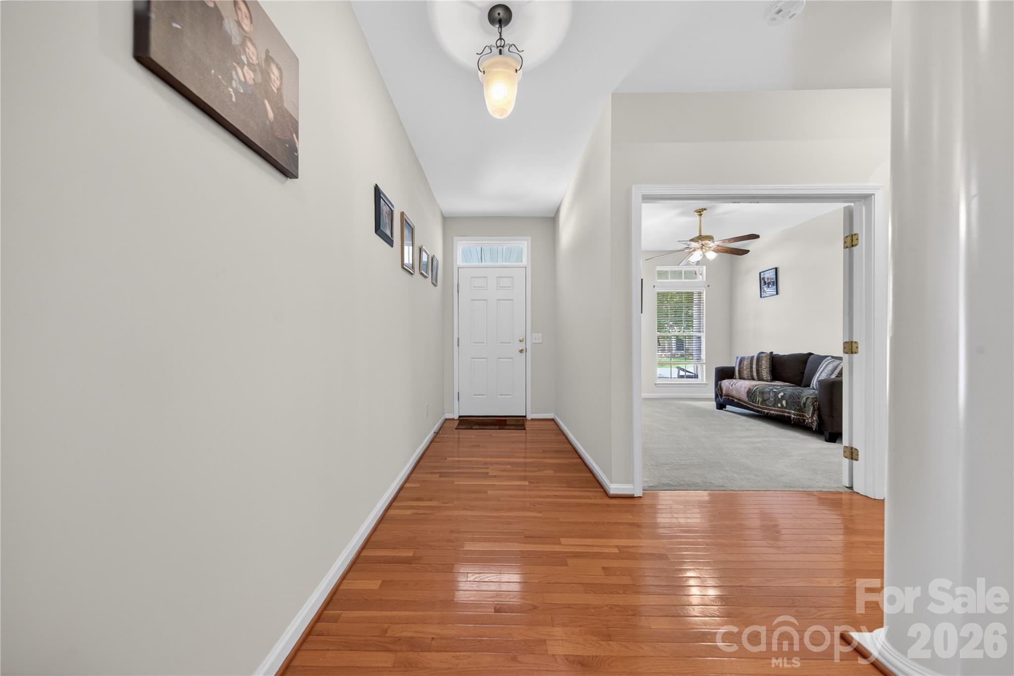 533 Fair Oaks Drive Fort Mill, SC 29708 - Photo 3 of 33 a view of a hallway with wooden floor and chandelier