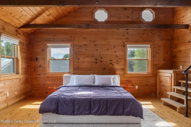 a bedroom with a bed and a window