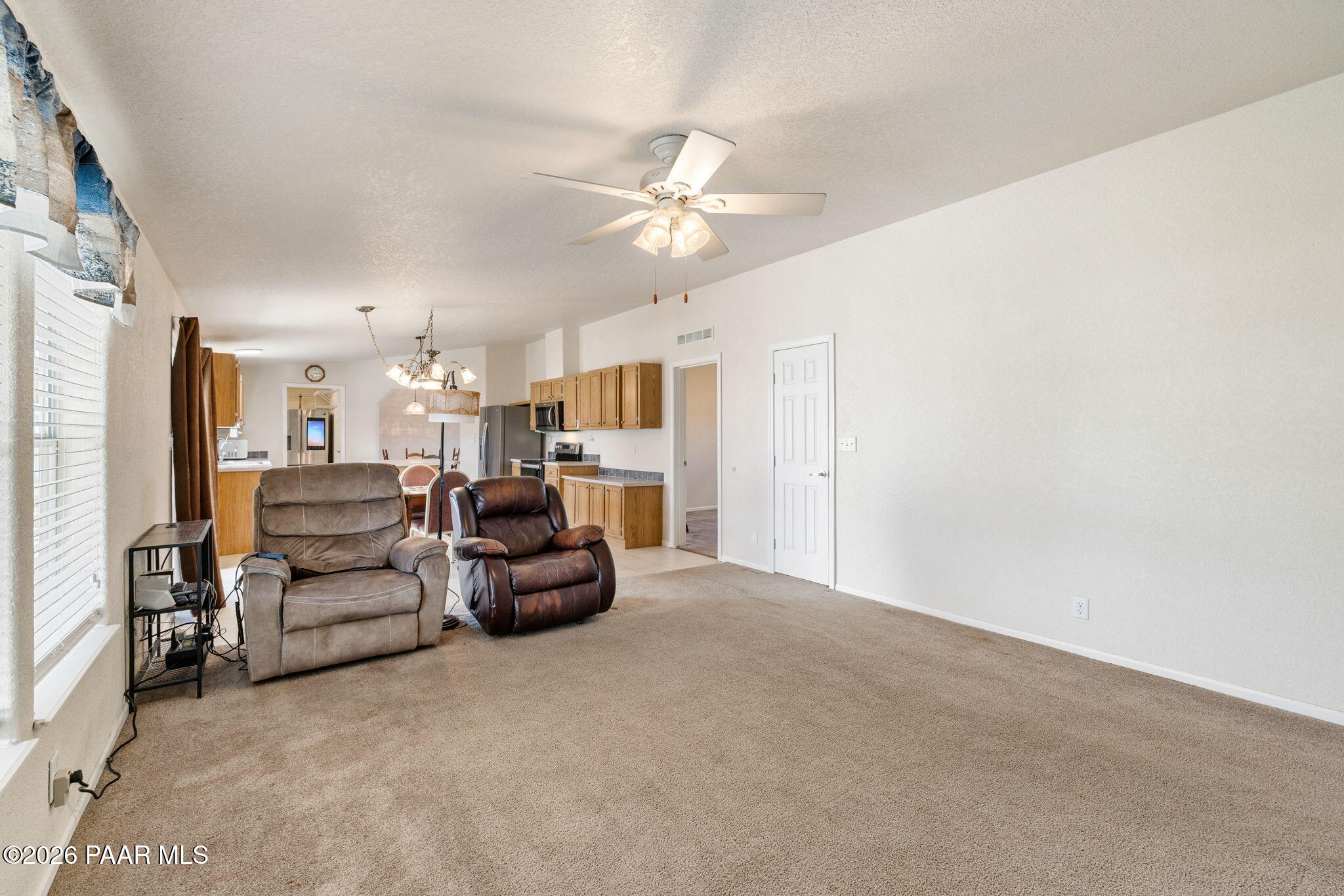 24680 North St Louis Street Paulden, AZ 86334 - Photo 11 of 33 a living room with furniture and a chandelier
