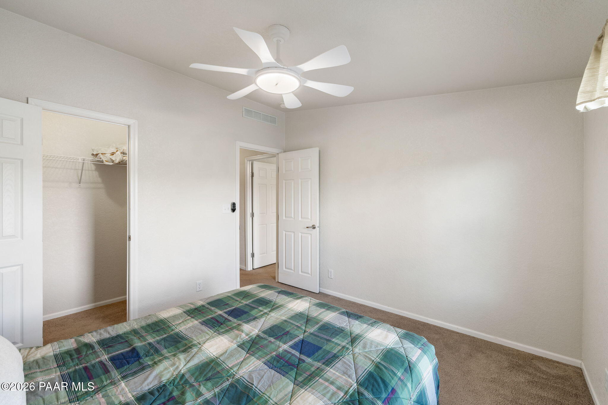 24680 North St Louis Street Paulden, AZ 86334 - Photo 16 of 33 a bedroom with a bed and a chandelier
